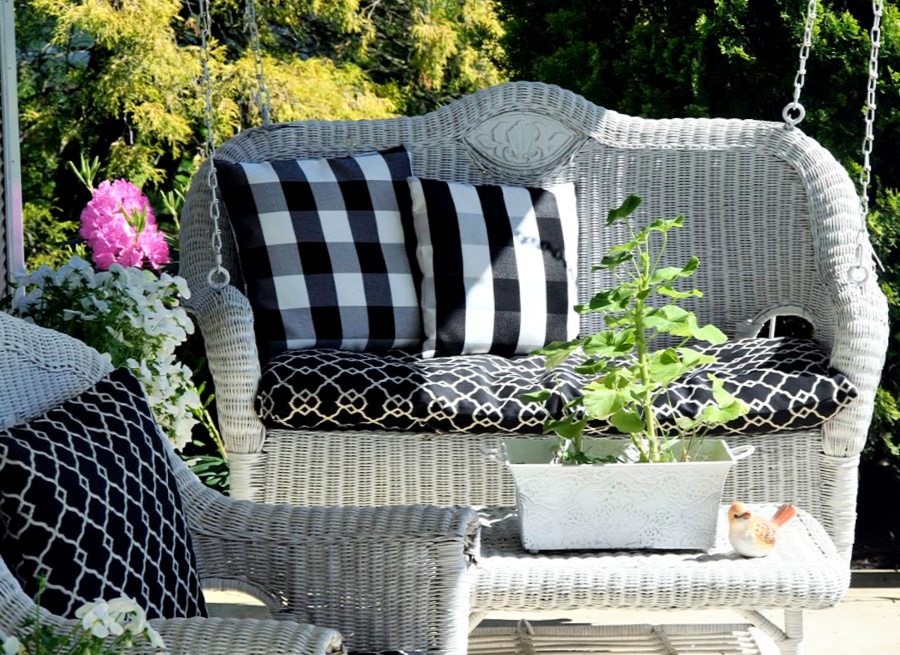Sprucing up and decorating with accessories, flowers and garden plants getting ready for leisurely  spring and summertime front porch living.