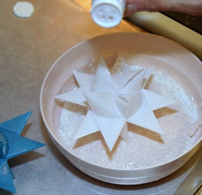 Tutorial for dipping folded paper German Stars in wax to preserve and protect from outdoor elements.