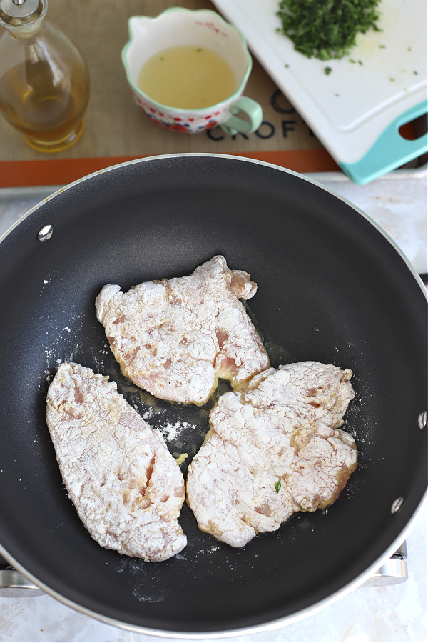 Sautéing chicken breast in skillet for Italian chicken francese. 