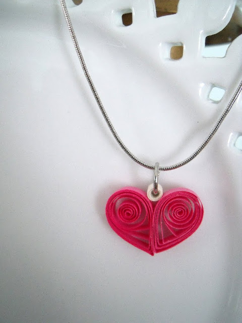 Paper quilling is a craft using thin strips of paper. Create flowers, tendrils and sweet little hearts to decorate and embellish all kinds of projects like this heart pendant.