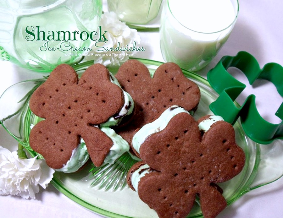 Easy recipe for homemade chocolate cookies cut into shamrock shapes with a cookie cutter. Spread with mint chocolate chip ice cream to create festive St Patrick's Day Minty Ice Cream Shamrocks treats.