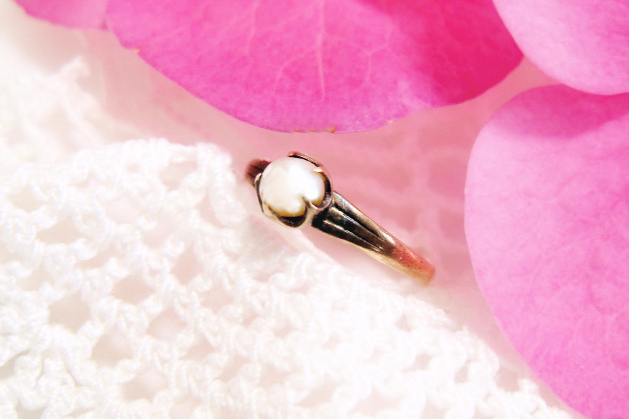 Tiny and sweet, mid-century pearl baby ring is a vintage keepsake. A sentimental gift from a beloved aunt and now worn on a chain as a necklace pendant.