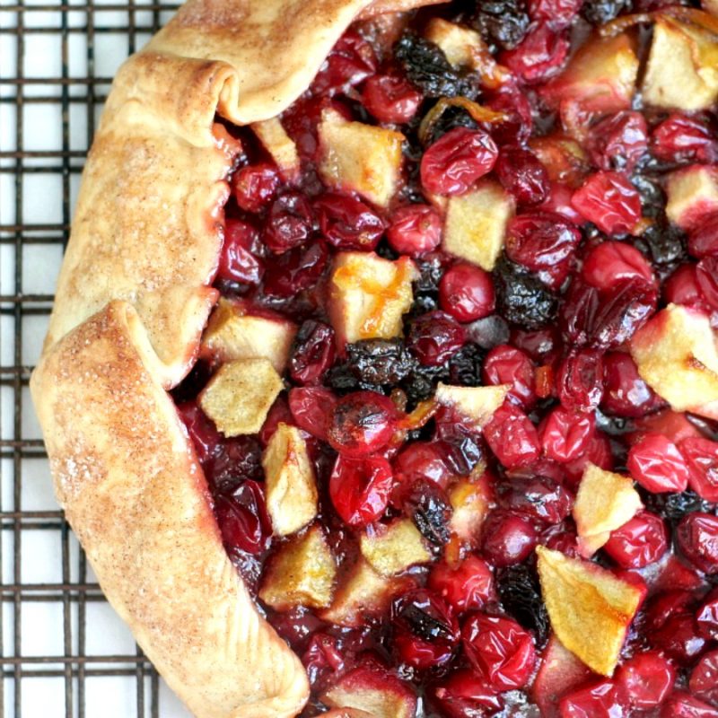 Easier than making a pie, Cranberry Lime Galette is both beautiful & delicious. Folded crust is filled with fresh and dried cranberries, apples and raisins.