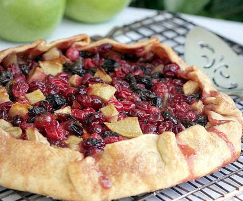 Easier that making a pie, Cranberry Lime Galette is both beautiful & delicious. Folded crust is filled with fresh and dried cranberries, apples and raisins.