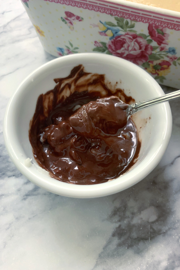 Melting chocolate with shortening for topping Peanut Butter Frosted Brownies recipe.