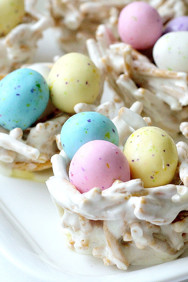 Cute, edible Easter springtime bird nests are adorable for Easter. Pretty pastel candy eggs nestled in twig-like bundles make a lovely welcome to dinner guests. They are made using Chow Mein noodles giving the appearance of sticks gathered by the birds to construct their nests.