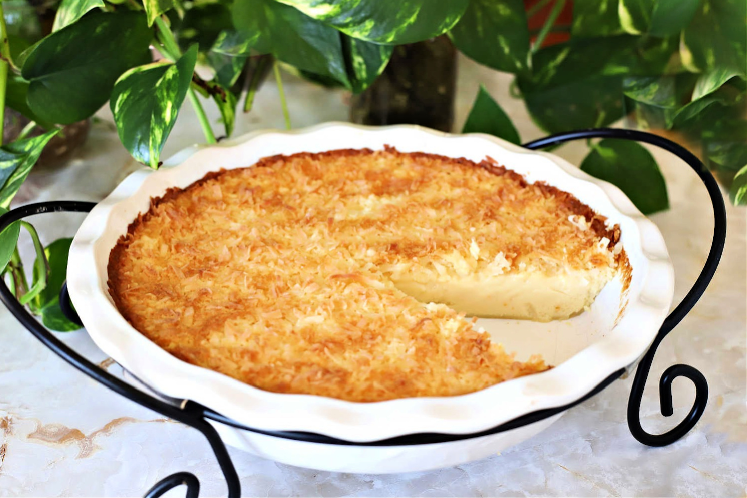 Super easy recipe that is delicious and always a favorite. Creamy Impossible Coconut Custard pie creates its own crust and takes just a few minutes to prepare. Add ingredients to a blender, pour into a pie pan, top with coconut and bake. It is that easy!
