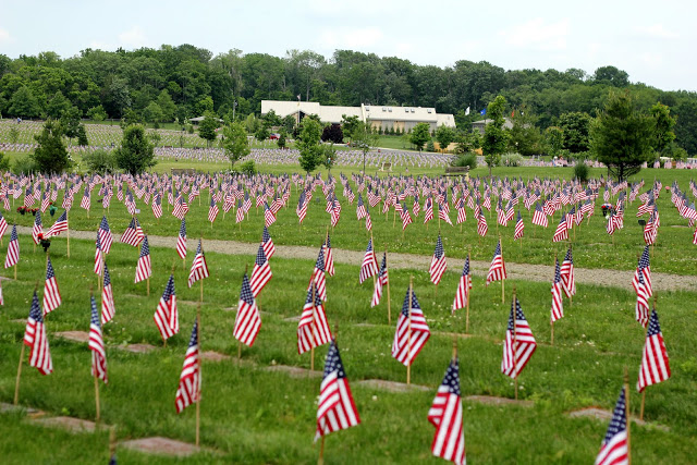 Remembering Memorial day and those who served including World War 1 and World War 2 with American flags decorating each grave at Brigadier General William C. Doyle Veterans Memorial Cemetery.