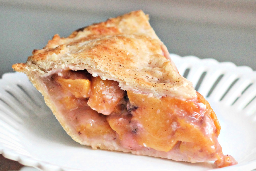 Fresh peach pie made with a homemade pie crust for a perfect summertime dessert. Easy recipe for crust or use a purchased crust for ease and to save time.