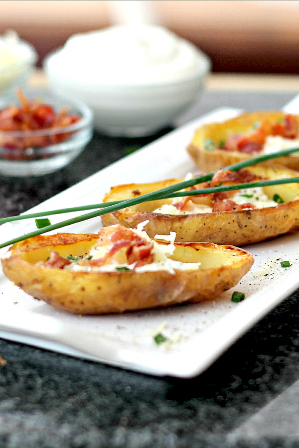 Oven crisped Potato skins make an easy and delicious appetizer. Baked until crisp and loaded with bacon, cheese, green onions or sour cream.