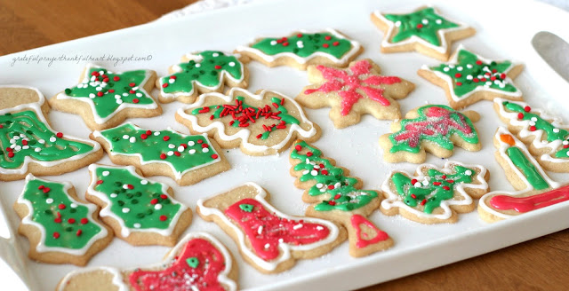 Frosted Sugar Cookies are festive and fun for holidays or birthdays. Easy recipe for cookies and frosting to make the prettiest and tastiest cookies!