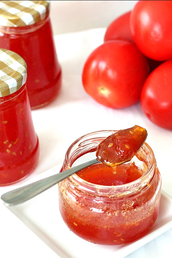 Make a delicious tomato jam using just garden fresh tomatoes, sugar and lemon or line juice. An easy, vintage recipe handed generations for canning, spreading on crackers as an appetizer or spreading on toast or biscuits. 