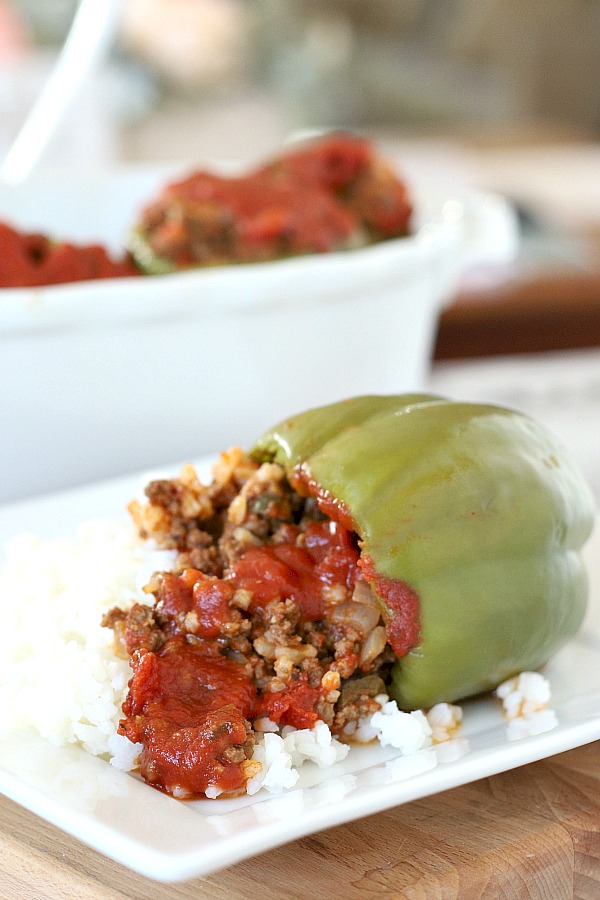 Sweet bell peppers filled with ground beef and rice and topped with your favorite sauce is a great dinner favorite.