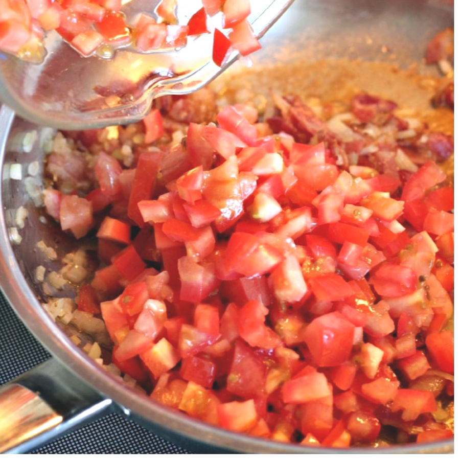 Easy recipe for bacon tomato jam, of sauteed bacon and sweet onions. A savory condiment with a little kick perfect for burgers, eggs and veggies.