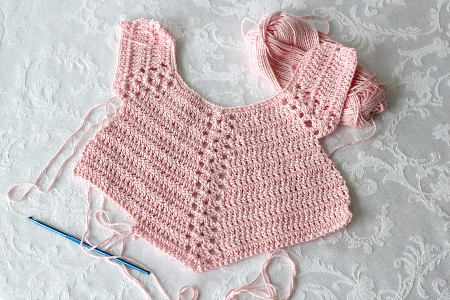 Sweet crochet baby bib is adapted from a vintage pattern and perfect for a toddler. Almost too pretty to use as a bib but adorable to dress up an outfit.