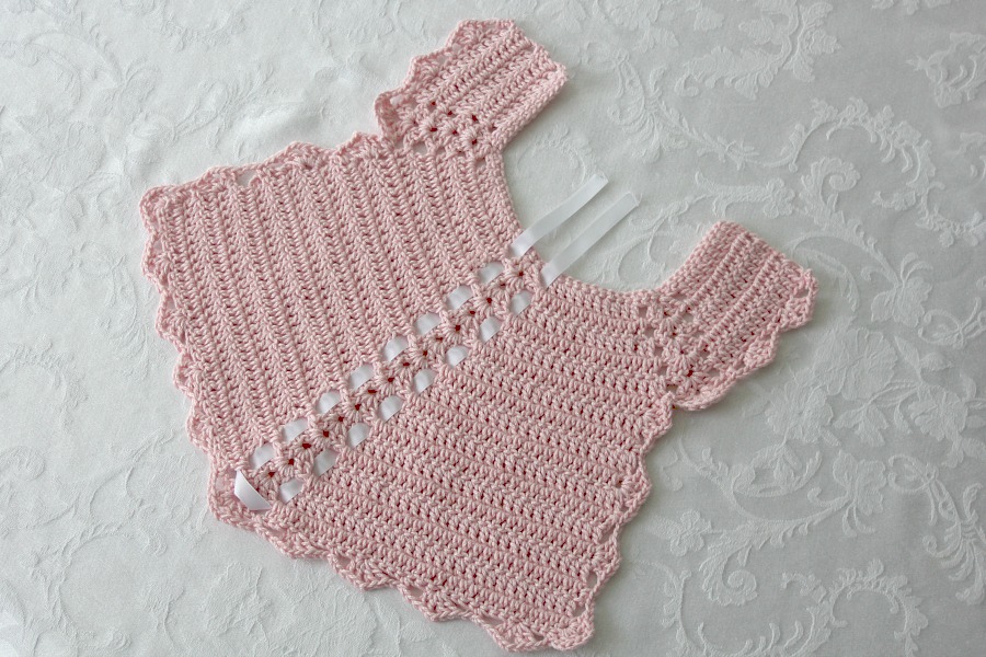 Sweet crochet baby bib is adapted from a vintage pattern and perfect for a toddler. Almost too pretty to use as a bib but adorable to dress up an outfit.