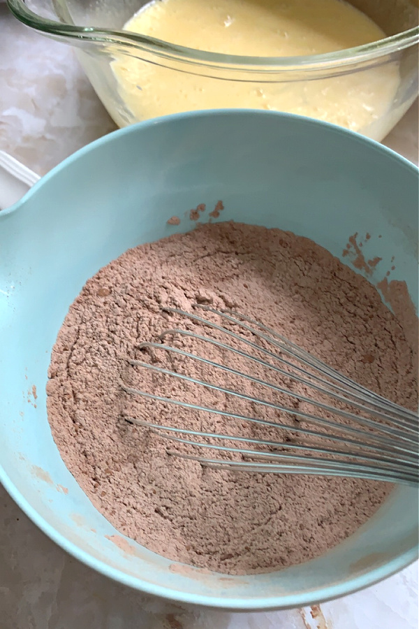 adding cocoa powder and espresso to make the batter for cream cheese chocolate zucchini bread