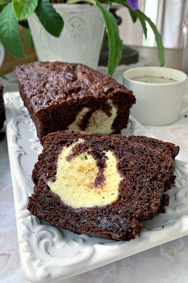 Easy recipe for swirled double chocolate zucchini bread. Moist and delicious with cream cheese & chocolate chips swirled throughout.