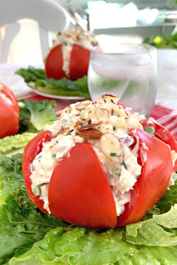 Use fresh garden tomatoes for creamy chicken stuffed tomatoes filled with fresh herbs, pineapple and cream cheese for a light summer lunch.
