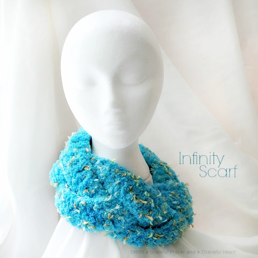 Easy crochet pattern for short version infinity scarf. Works up quickly and pattern is easily adapted. Pretty aqua yarn.