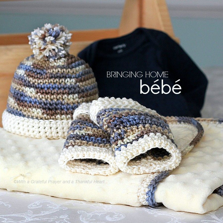 Crochet edge baby blanket with a sweet border around a fleece fabric with matching infant beanie and tiny leg warmers makes a lovely baby shower gift.