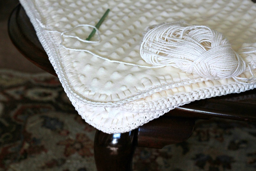 Crochet edge baby blanket with a sweet border around a fleece fabric creating a cozy, snuggly lovey. Perfect baby shower gift or as a sofa throw.