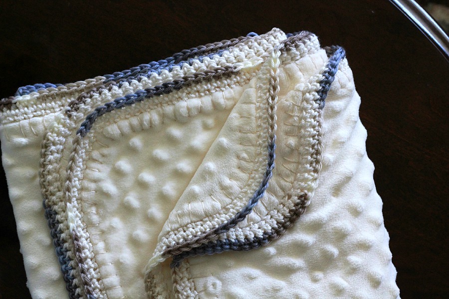 Crochet edge baby blanket with a sweet border around a fleece fabric creating a cozy, snuggly lovey. Perfect baby shower gift or as a sofa throw.