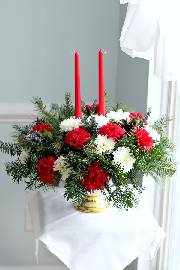 Easy DIY to make an inexpensive floral Christmas centerpiece using greens from your yard and flowers from the produce store or grocery store. Brighten your home for the holidays with flowers!