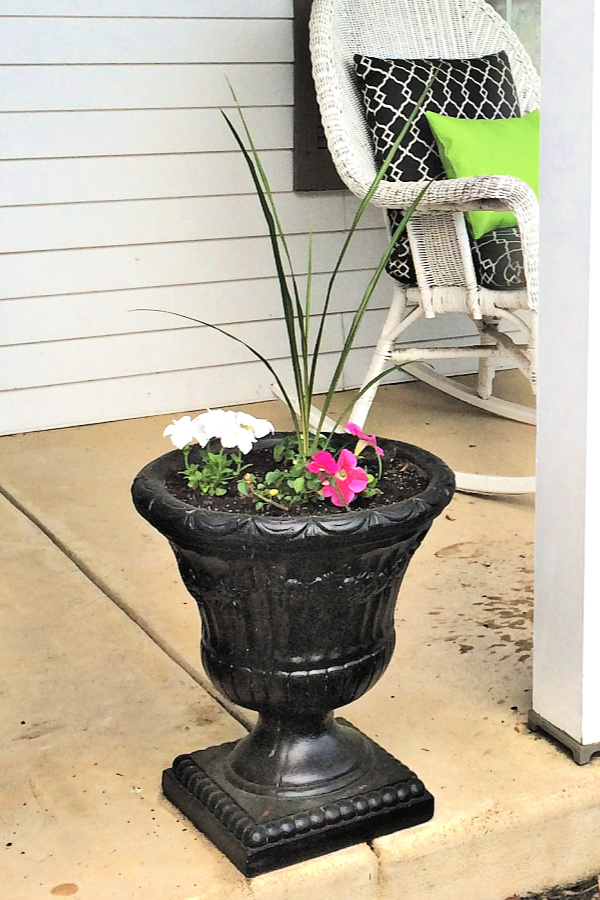 A garage sale urn was a DIY project. A little work and a new coat of paint resulted in a beautiful, farmhouse style porch planter for spring garden flowers with lots of curb appeal. Shade loving annuals flowers and coleus do exceptionally well.