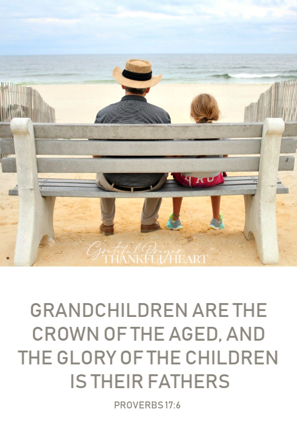 A girl and her grandfather on a bench at the beach enjoying the ocean view. Memories, relationship and love between the generations. 