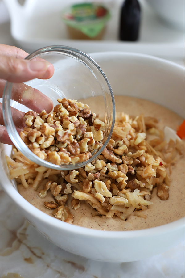 Adding walnuts or pecans to the apple walnut Bundt cake batterBatter for apple walnut Bundt cake recipe