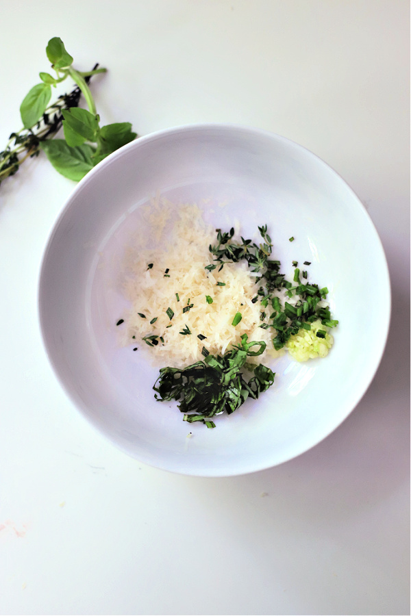 Easy recipe for making baked eggs with fresh herbs and Parmesan cheese in the oven.