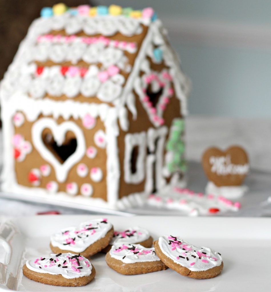 Super sweet Valentine's Day Gingerbread House is magical. Decorate with Royal Icing as the glue for favorite candy and treats. Great kids project.
