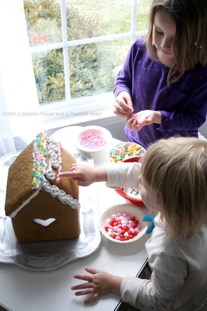 Super sweet, to make, Valentine's Day Gingerbread House. Decorate with Royal Icing as the glue for favorite candy and treats. Great kids project.