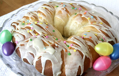 A beautiful Easter egg braided yeast bread tastes delicious and is so pretty with dyed eggs tucked into the braided ring then drizzled with a light glaze. Easy recipe using a bread machine to make the dough.