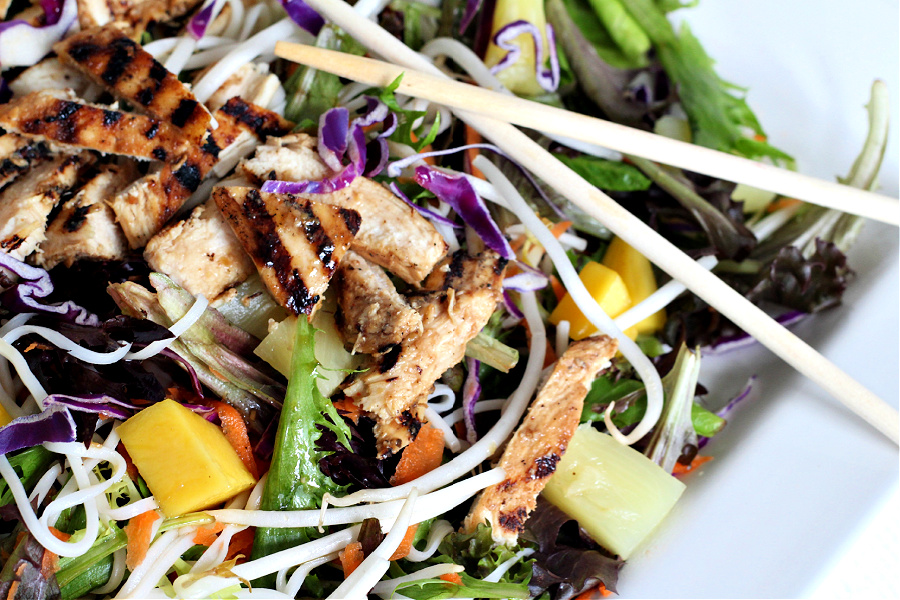 Chicken pineapple mango Asian salad with romaine, carrots, bean sprouts, and chow mein noodles in a flavorful and refreshing dressing. 
