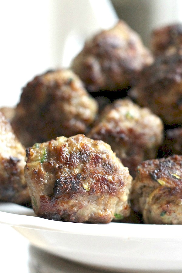 Add more veggies to your family meals. Try this delicious recipe for zucchini meatballs with shredded zucchini. So much flavor in these pan-fried meatballs.