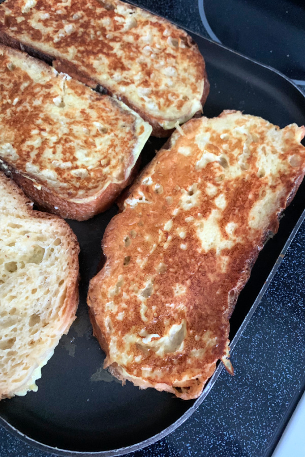 frying egg dipped bread for French toast breakfast