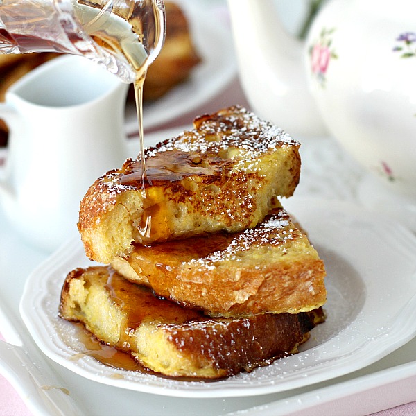 Thick slices of French Toast dusted with confectioners' sugar and served with maple syrup and fruit. It is like eating dessert for breakfast!