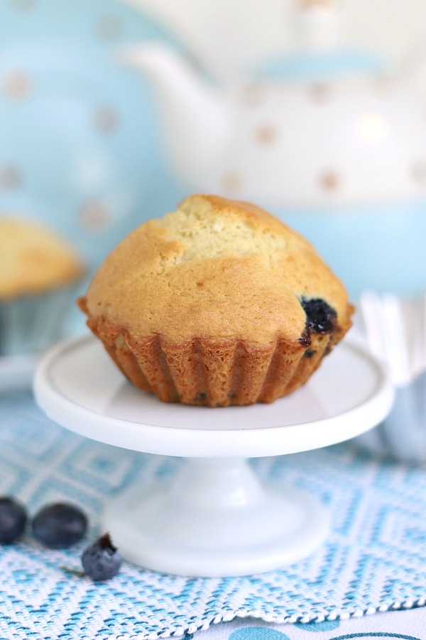 Easy blueberry muffins are made lighter by substituting applesauce for some of the butter for a yummy, cake-like breakfast or snack time treat.