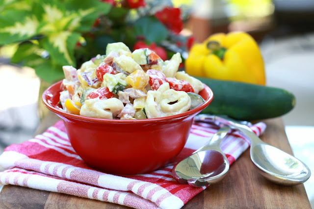 Hawaiian Pasta Salad, brightly colored with an abundance of crisp veggies is a perfect summer salad. It is a hearty one too, with the tortellini and diced ham. A great entree served with crusty bread (and maybe a glass of wine) for a lovely summer supper.