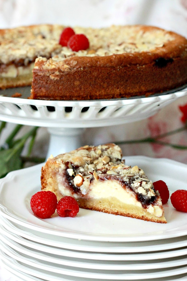 Easy recipe for Raspberry Cream Cheese Coffee Cake with a deep golden brown crust and sweet cream cheese filling with raspberry preserves and a crunchy almond topping.
