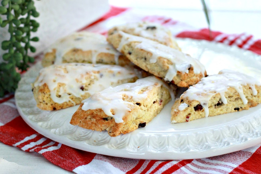 Easy recipe for anise cranberry orange scones are drizzled with glaze so perfect for breakfast, snacking. Package up a batch and surprise a friend or coworker with a thinking-of-you gift.