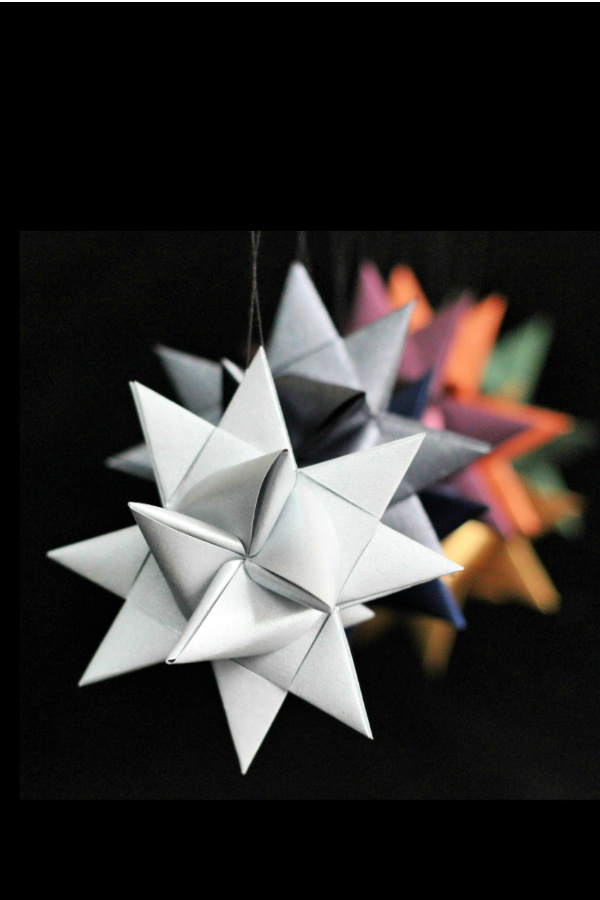 You can make folded paper German stars like you remember from your childhood! Follow this easy, step-by-step video tutorial with your kids or grandchildren. A fun craft DIY to make ornaments, decorate presents and for gift-giving. 