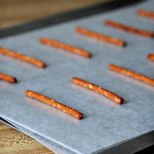 preparing pretzel sticks for adding melted chocolate.