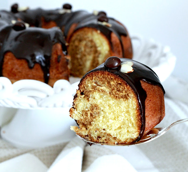 How to make an easy Coffee Marbled Bundt Cake with Dark Chocolate Ganache. Great birthday or any occasion dessert. Swirls of yellow cake and coffee flavored cake with a decadent dark chocolate ganache drizzled on top.