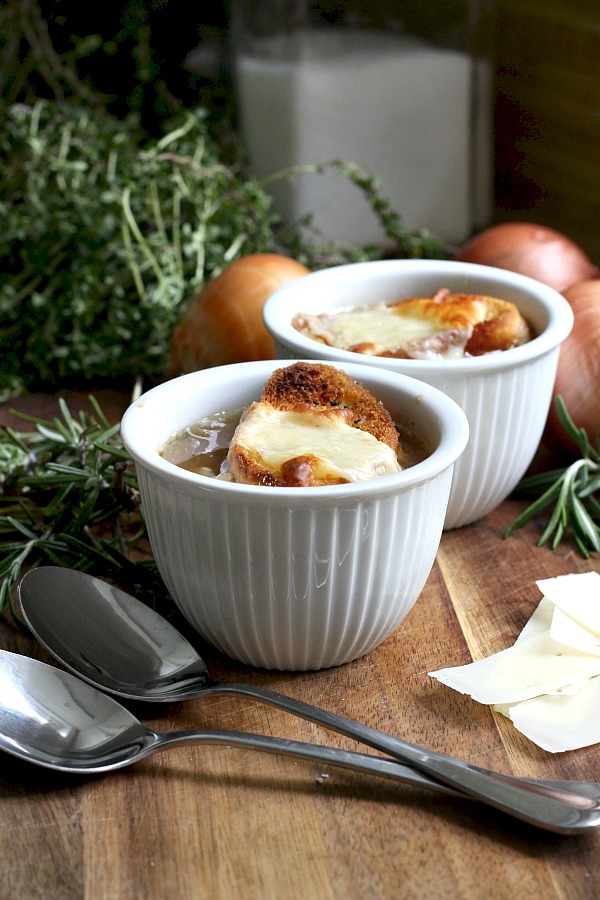 Easy recipe for French Onion soup in a rich beef broth with sweet caramelized onions and topped with toasted baguette and melty cheese. 