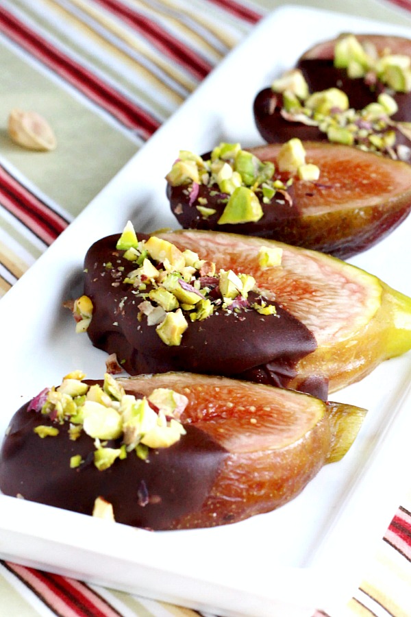 Easy and elegant sweet, after dinner dessert of fresh figs from backyard tree dipped in chocolate and topped with chopped pistachios.