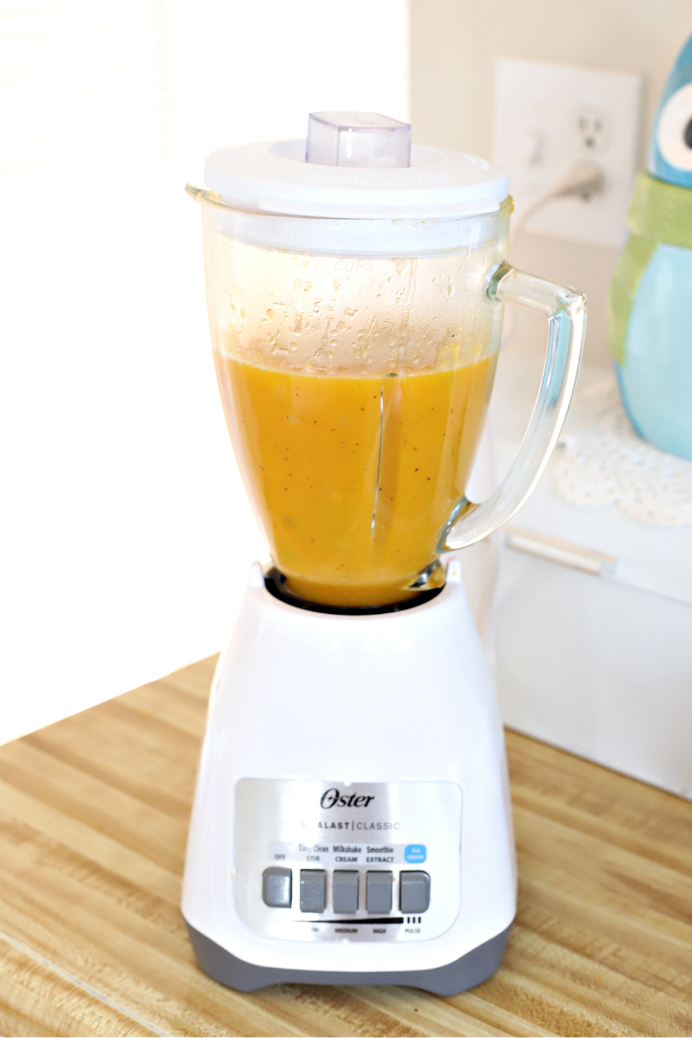 Using a blender to puree the butternut squash soup