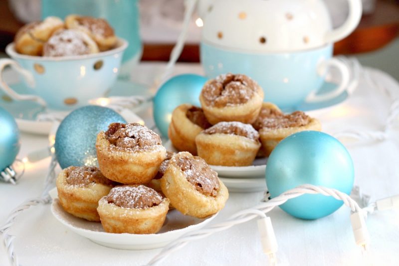 These sweet little tartlets called Pecan Tassies are like having a bite-sized pecan pie. Sweet filling in a cream cheese, flaky cup, they are also known as Nut Lassies.